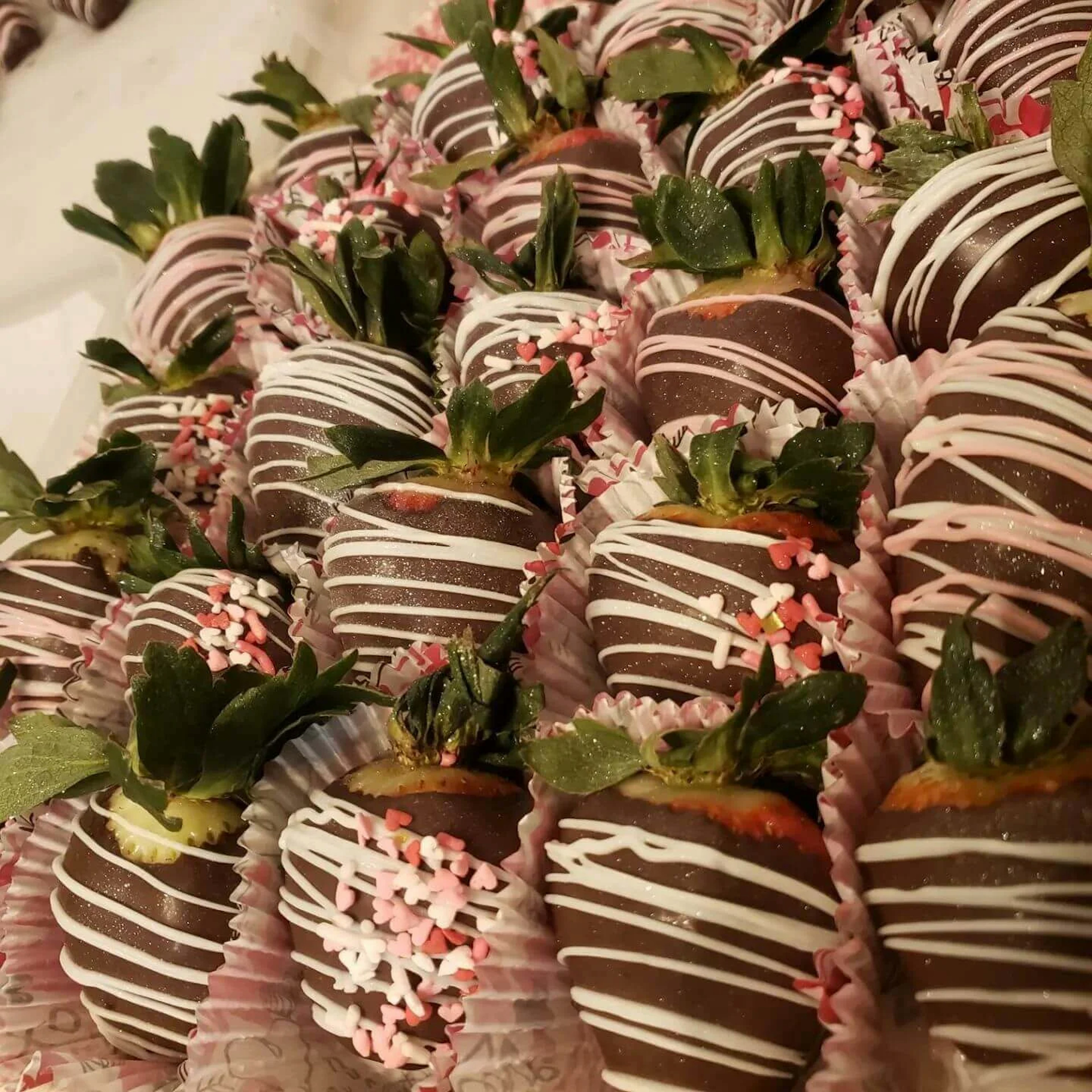 Chocolate strawberries covered with white chocolate drizzle.