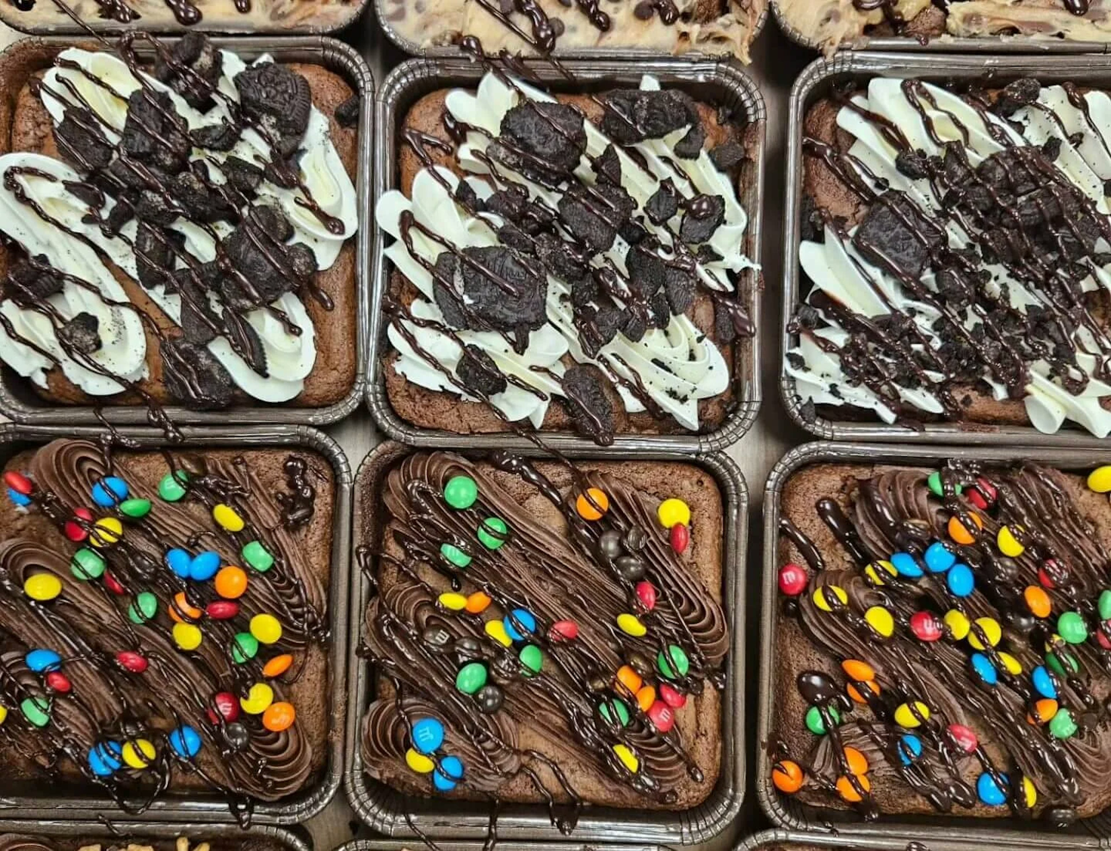 Assorted brownies sitting in pans.