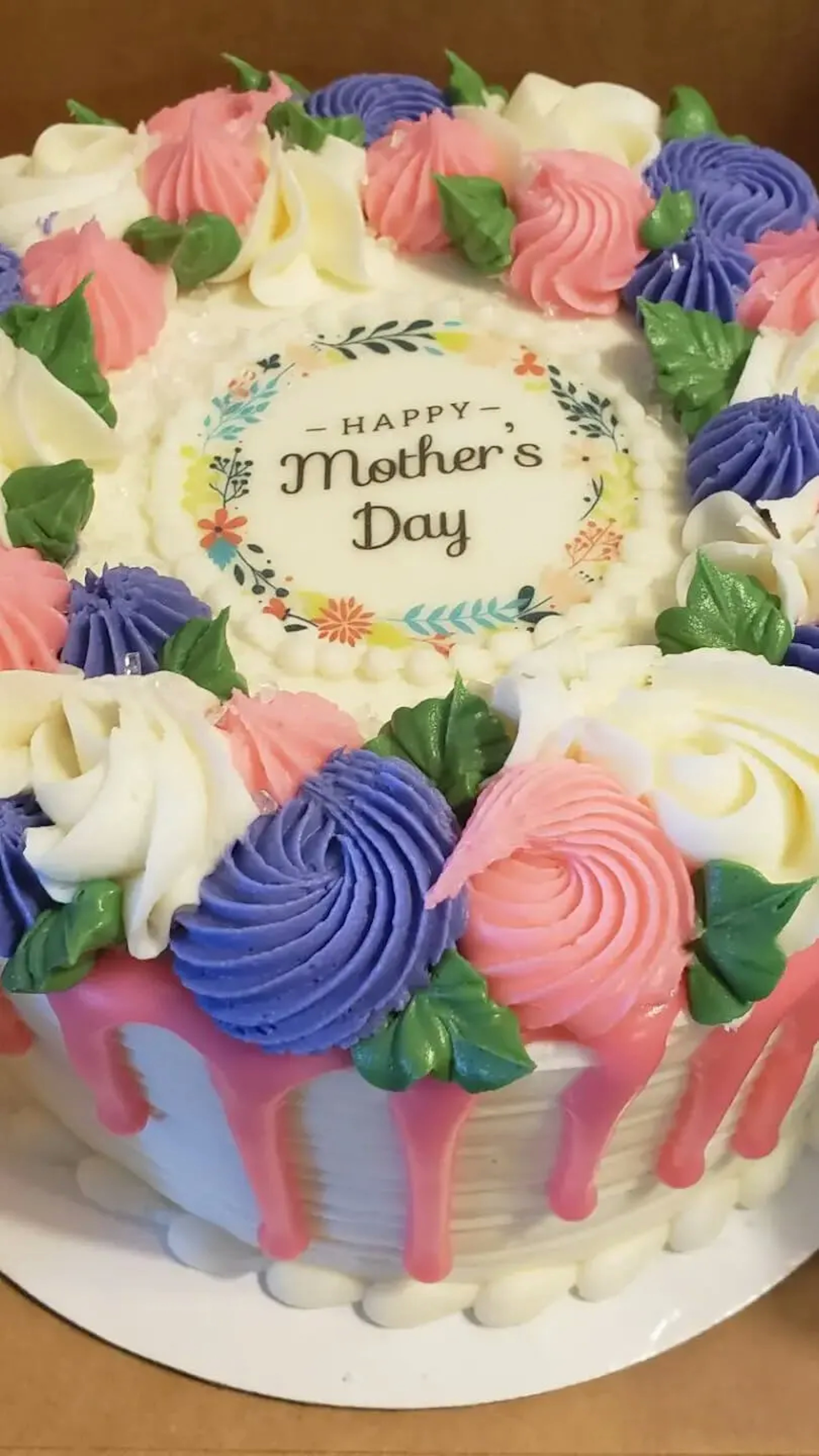 A festive Mother's Day cake deocarted with multi-color flowers.